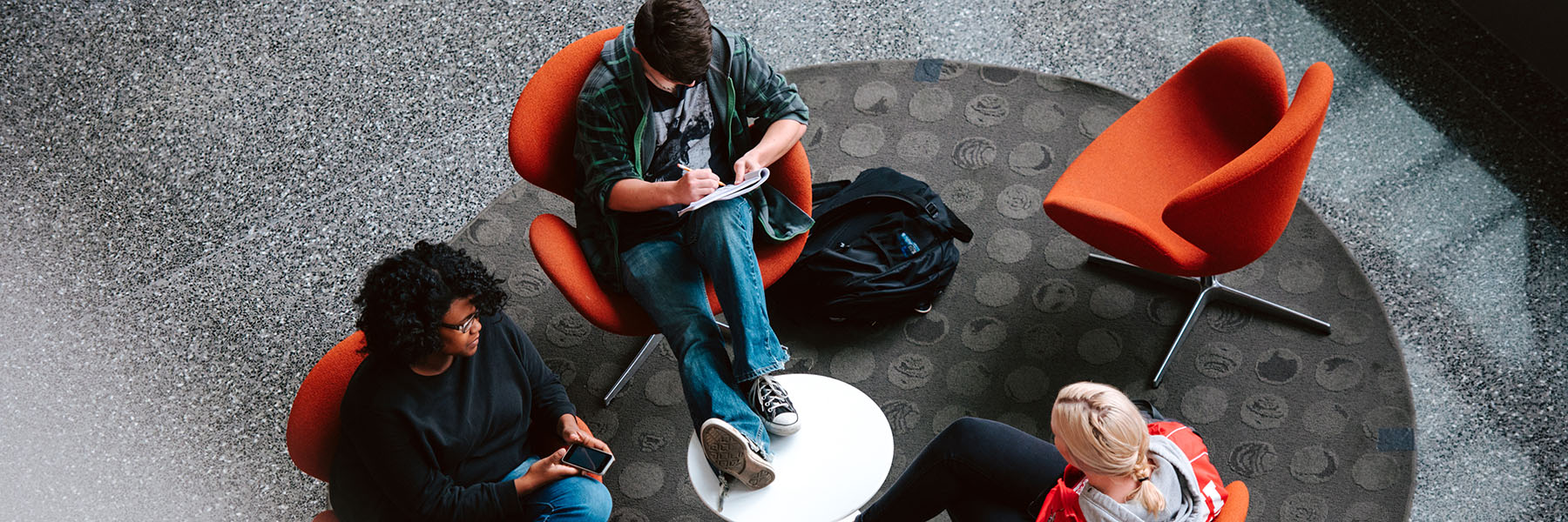 Three students working together in the campus center.